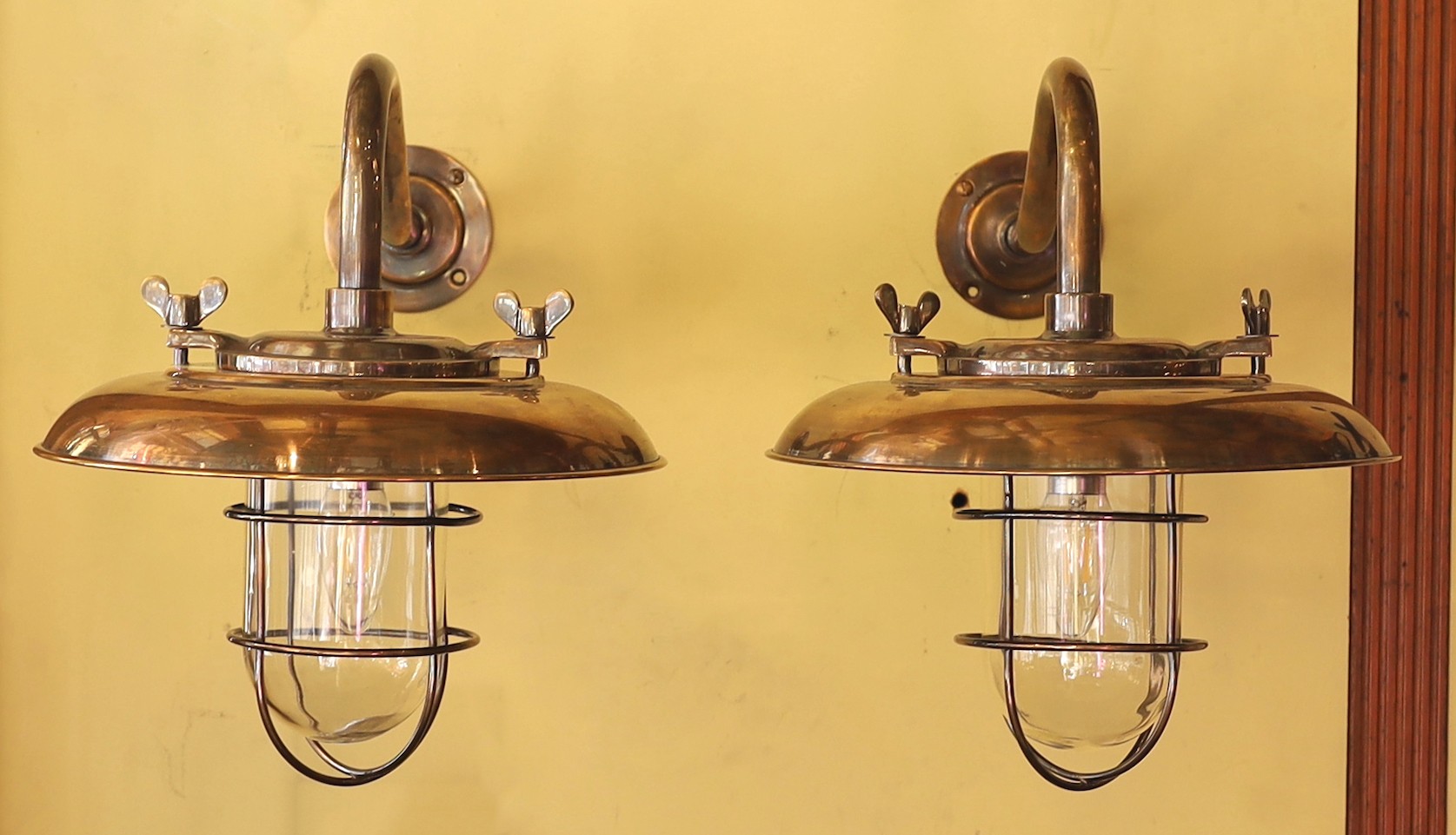 A pair of nautical style bronzed metal wall lights, height 35cm. diameter 35cm